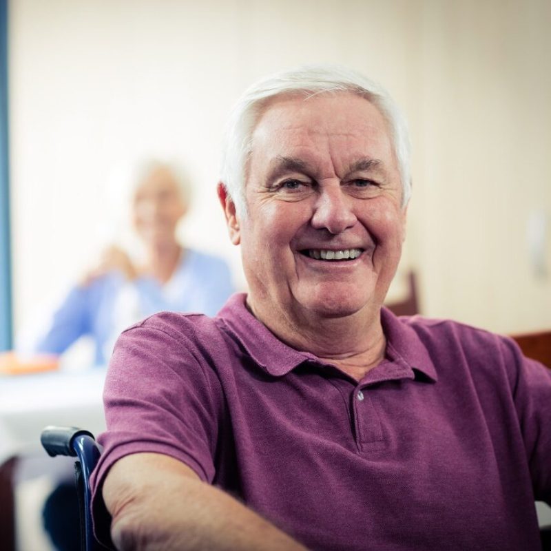 Happy elderly man smiling at the camera